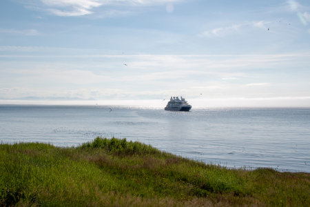 Landscape of boat approaching Grimsey Island