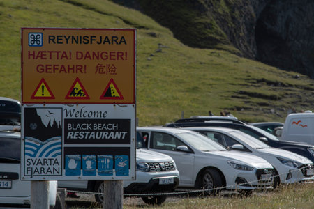 Landscape of entrance warning sign at Reynisfjara Black sand Beach Vik