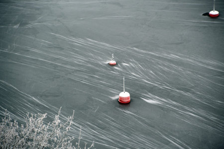Landscape of red buoys in a frozen river in Stockholm Sweden