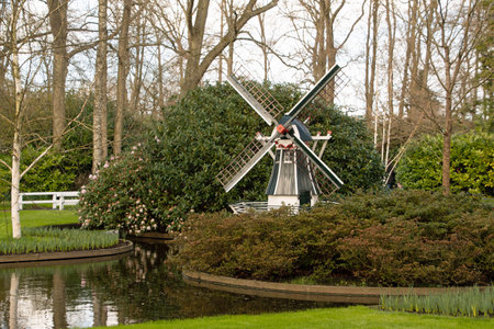 Landscape of field of windmill by canal at Keukenhof gardens in Lisse Holland The Netherlandsの写真素材