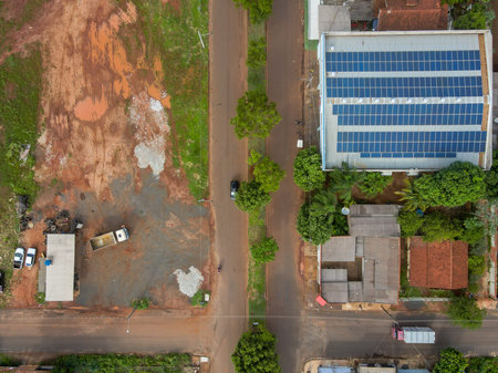 Aerial top down of solar panels on roof and rural road in Tangara da Serra in Mato Grosso Brazil