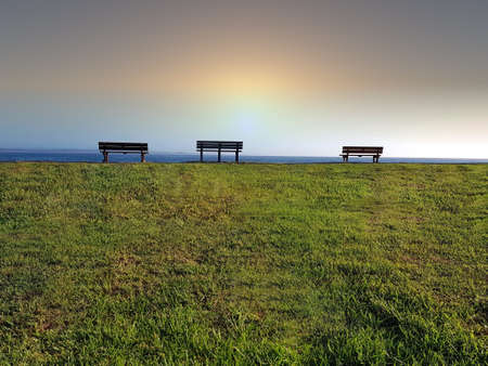 Three bench seats on the horizonの写真素材