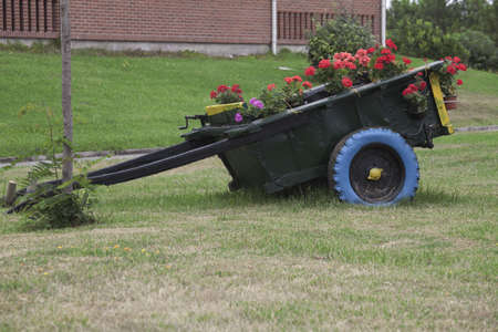 old wagon decorated with flowers in the gardenの写真素材