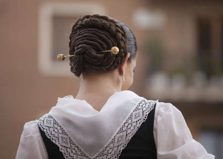 Valencia, Spain- October 9th, 2010: Fallera woman, with typical clothes and traditional braided bun のeditorial素材