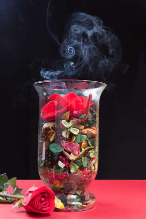 roses and flowers and smoke aromatic candlesの写真素材