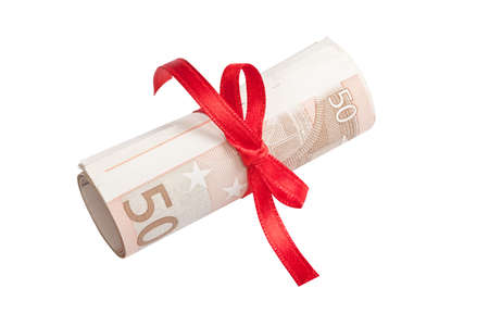 Euro banknotes roll tied with a red ribbonの写真素材