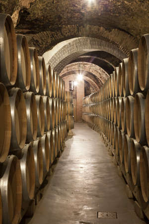 Valladolid, Spain, July 9th, 2011. Interior of old cellar vaults of brick, the Ribera del Duero, with wine barrels stackedのeditorial素材