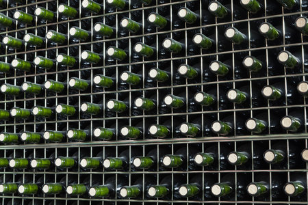 Shelf with bottles of red wine
