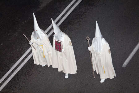 Easter penitents with the sacred book of the Brotherhood, at nightのeditorial素材