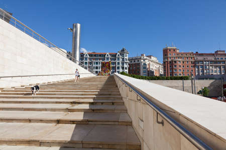 Bilbao, Spain - June 15, 2012: Stairs side of the Guggenheim Museum Bilbao, which end in the most classical buildings in the city. There are people walkingのeditorial素材