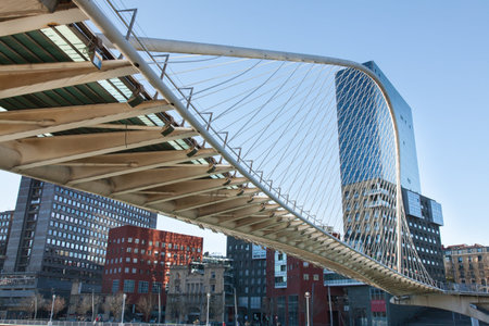 BILBAO-DECEMBER 23: Zubizuri Bridge, Santiago Calatrava in Bilbao, Spain, on December 23, 2012. It is an arch bridge that hangs over the river Nervión のeditorial素材
