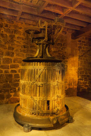 Former press grapes to make wine in a cellarの写真素材