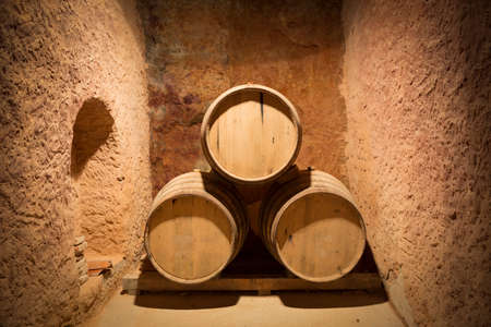 wine barrels in the cellarの写真素材