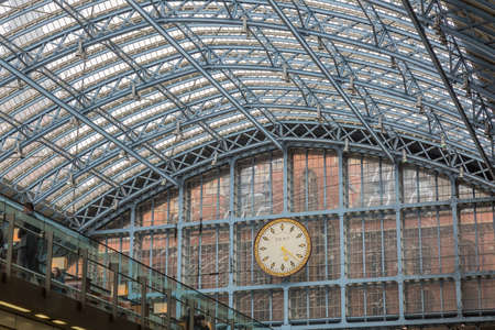 London, UK - May 13, 2016; Clock under the glass dome of the Train station of St. Pancrasのeditorial素材