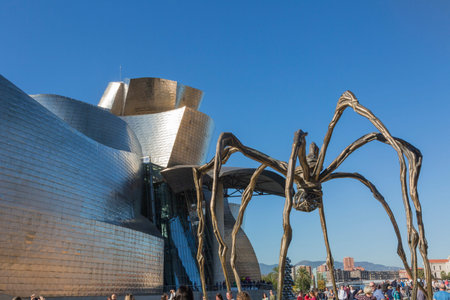 Bilbao, Spain - October 29, 2016; Back of the Gugenheim Museum, contemporary art, work of the Canadian architect Frank O. Gehry, and the sculpture of the spider of Louise Bourgeoisのeditorial素材