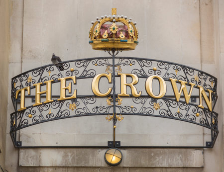 Oxford, UK - May 15, 2016; Commercial establishment, called the crown, with a golden sign in the...