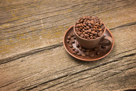 Coffee beans in a cup on old boards, rustic styleの写真素材