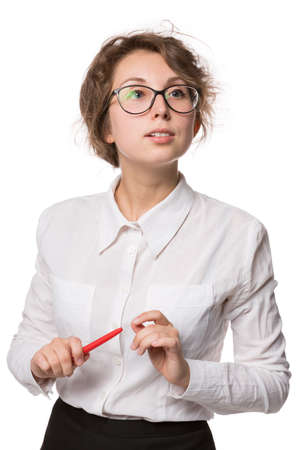 Girl in a white blouse stands on a white background, gestures, emotions on her faceの写真素材
