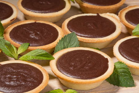 Tartlets with chocolate cream on the tableの写真素材