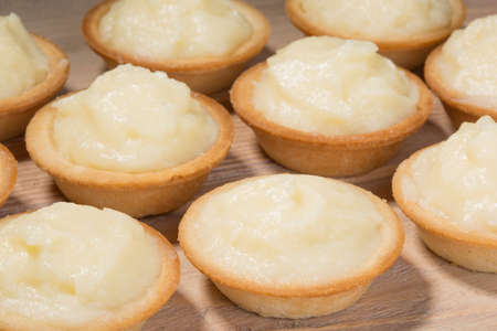 Tartlets with custard on the tableの写真素材