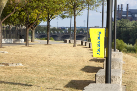 Yellow emergency call box in a park 