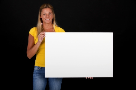 Blond woman holding a whiteboardの写真素材