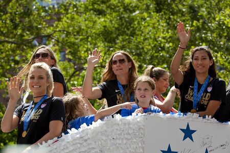 U.S. women's soccer team Julie Johnston, Abby Wambach , Whitney Engen Goalkeeper Hope Solo ,Christie Rampone, and New York Governor Andrew Cuomo, at back of float wave to the crowd as their float makes it way up Broadway's Canyon of Heroes during the tickのeditorial素材