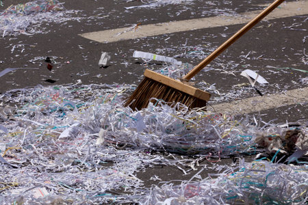 Pieces of paper and streamers being swept up with a broom after the Ticket-tape Parade for the FIFA...
