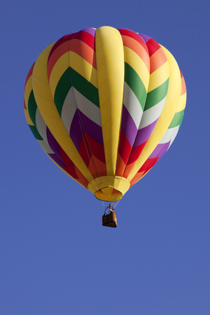 Colorful hot air balloons as part of the mass ascension launch of over 100 colorful balloons at the New Jersey Ballooning Festival in Whitehouse Station, New Jersey during the early morning race.の写真素材
