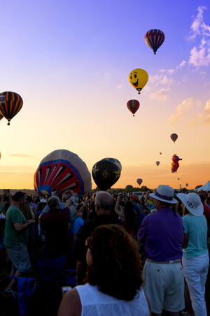 The mass ascension launch of over 100 colorful hot air balloons at the New Jersey Ballooning Festival in Whitehouse Station, New Jersey as a early morning race.のeditorial素材