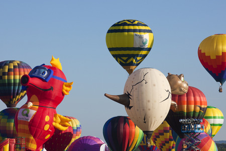 The mass ascension launch of over 100 colorful hot air balloons at the New Jersey Ballooning Festival in Whitehouse Station, New Jersey as a early morning race.の写真素材