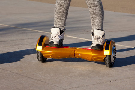 People riding on hoverboards or gyro scoter drive. Two wheel transport device. Electriic hyroscooter...