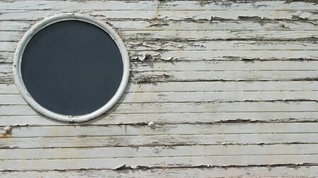 Porthole on wooden boatの写真素材