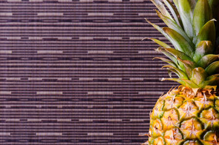 Half of pineapple in right side on gray stripes background, vertical shotの写真素材