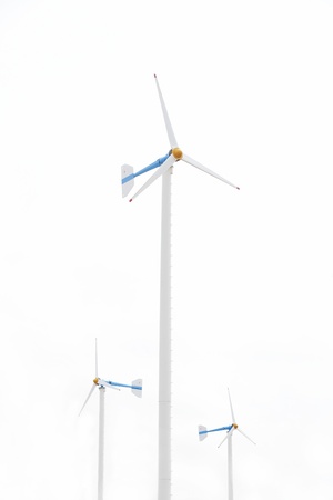 Three white wind turbine generating electricity on isolated background の写真素材
