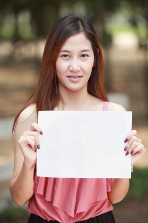 Young long hair Asia women and blank paper for put your text and your job の写真素材