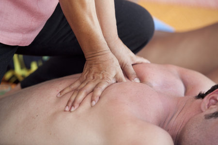Close-up of an attractive man having a back massage in a spa center
