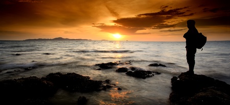 The man success for extreme travel with sunset.の写真素材