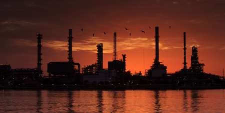 Container Cargo freight ship with working crane bridge in shipyard at dusk for Logistic Import Export backgroundの写真素材