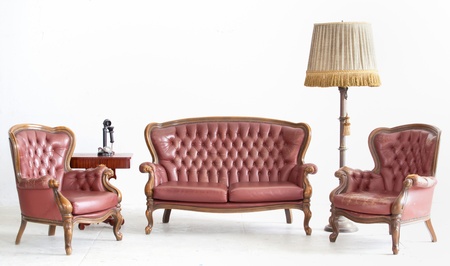 ancient leather sofa with lamp and telephone in white room の写真素材