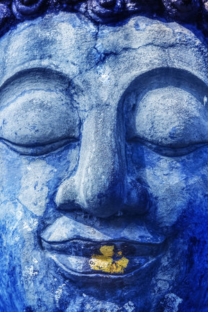 Buddha face with golden and blue.