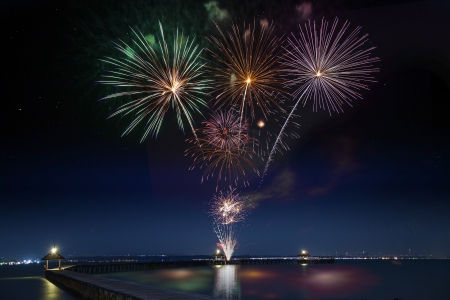 Wooded bridge in the port between new year celebration with firework.の写真素材