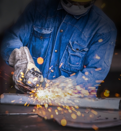 sparks while grinding in a steel factory の写真素材
