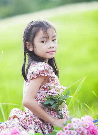 Little girl with green nature backgroundの写真素材