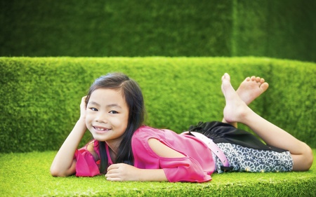 Baby girl taking relax on nature sofaの写真素材