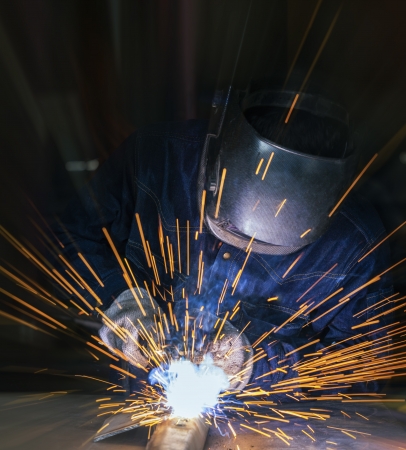 Worker welding the steel part by manual Worker welding the steel part by manual