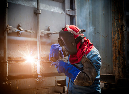 Worker welding the steel part by manual