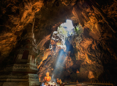 Sun Light in the cave at Khaoluang, with buddha statue and golden pagoda in Phetchaburi Province, Thailand.のeditorial素材