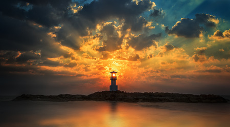 Lighthouse with light beam at sunset at Khao Lakの写真素材