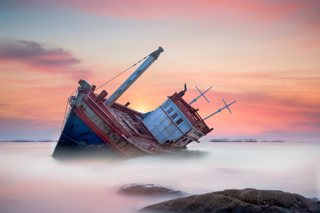 Fishing boat beached with sunset viewの写真素材